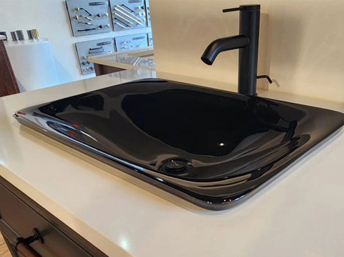 black bathroom sink with black faucet