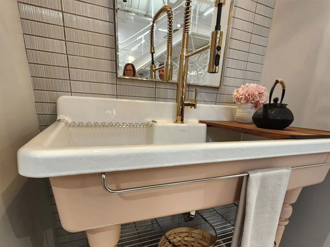 utility style kitchen sink with brass faucet